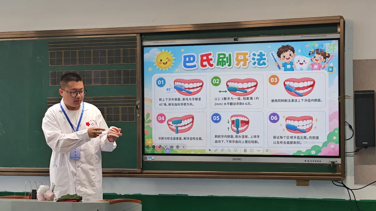 志愿者用牙齿模型演示巴氏刷牙法(2026-05-25 · 吉林蛟河)